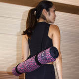 Yoga teacher carrying Felicidade yoga mat with black carrying strap